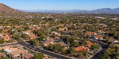 A drone shot of Scottsdale homes and mountains