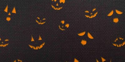 Jack-o-lantern eyes and mouths in orange on a black background