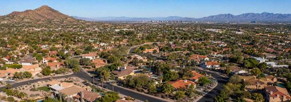 A drone shot of Scottsdale homes and mountains