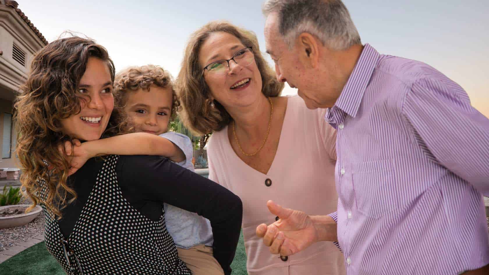 A young woman with her daughter and her parents in the backyard of their shared home in Scottsdale