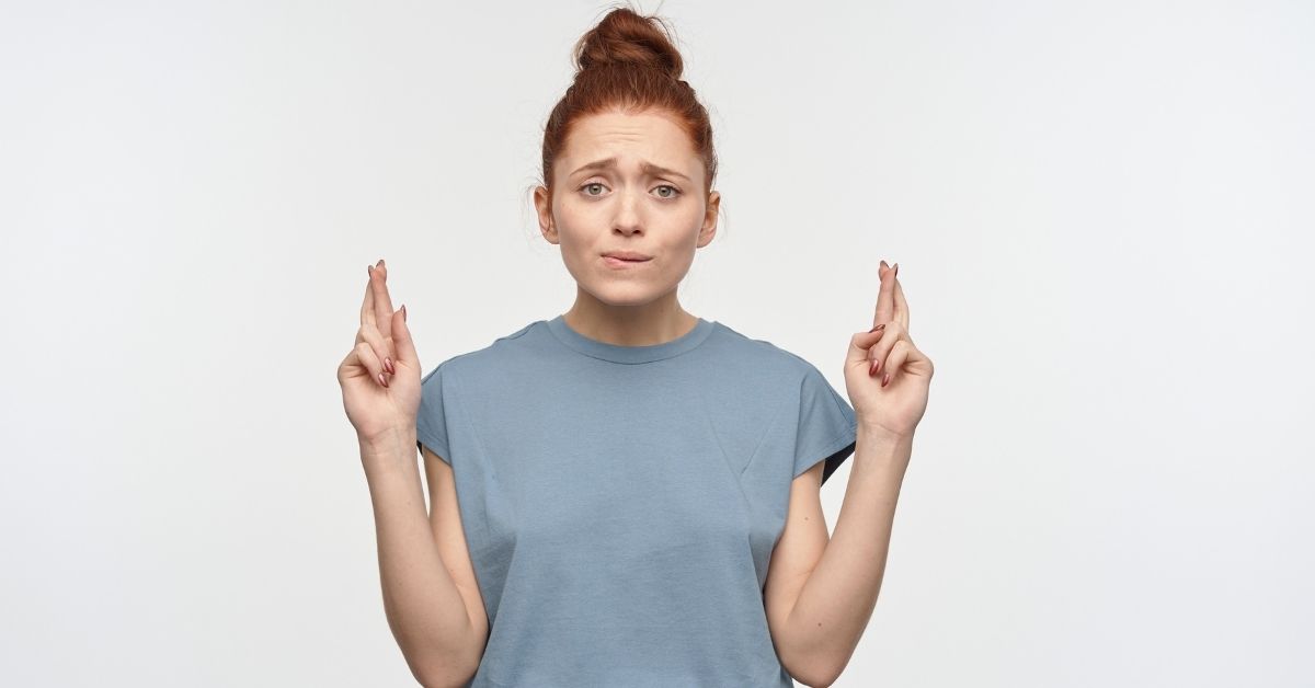 A woman hoping with her fingers crossed