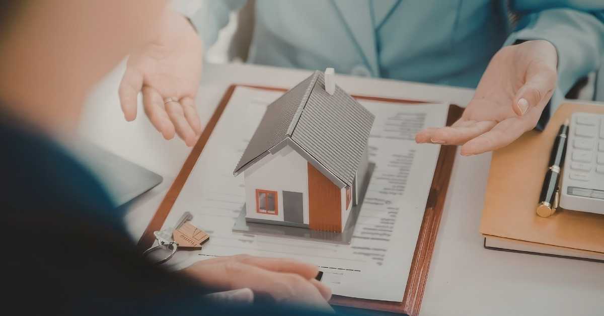 A little Scottsdale home for sale on a contract with a buyer and an agent sitting on two sides of a desk