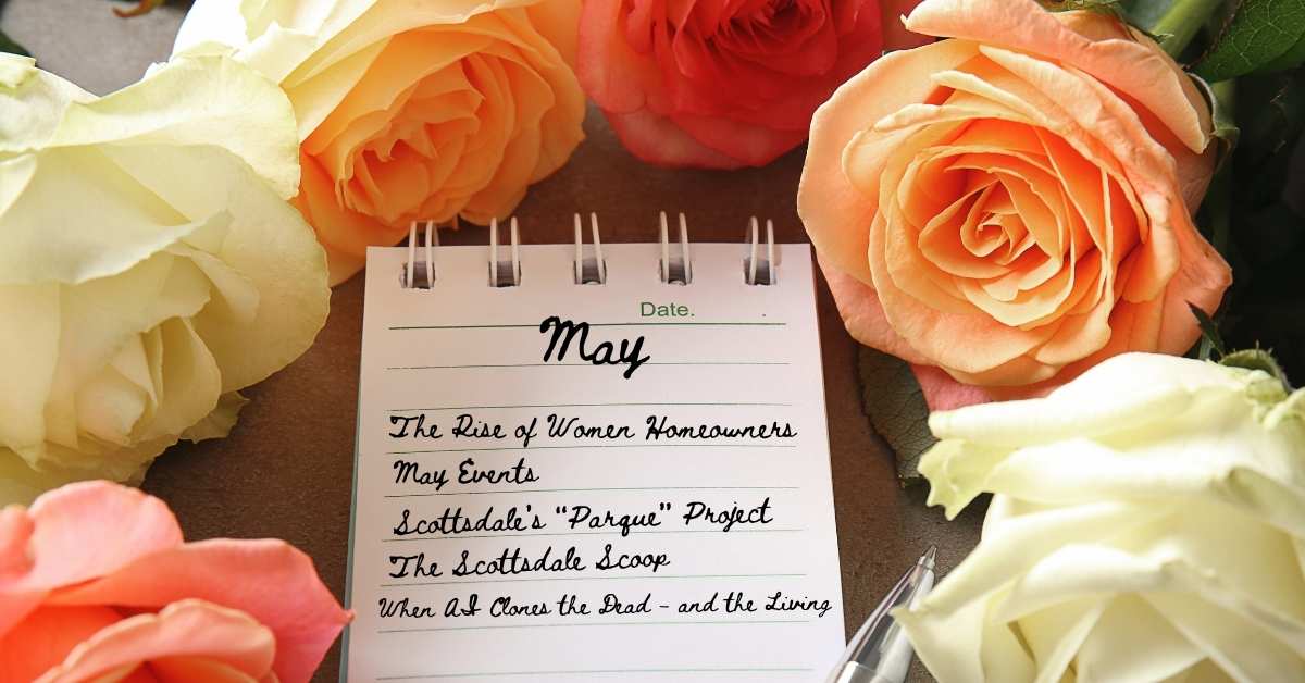 A small notebook with May written on it with a list of this newsletter's articles, surrounded by colorful roses 