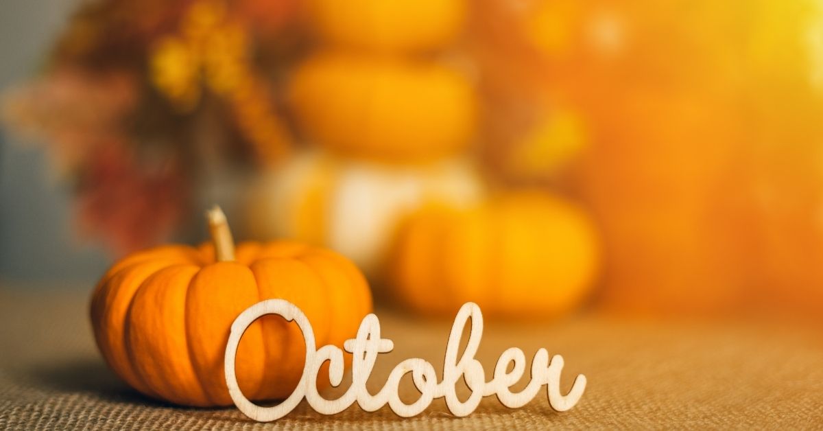 A pumpkin and orangey background with October in letters