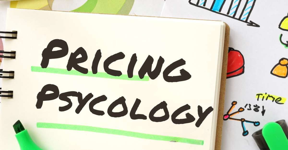A notebook with Pricing Psycology written on it with a marker