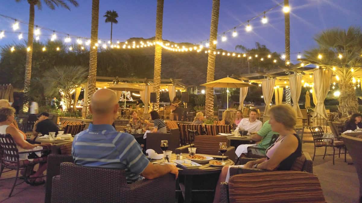 People dining al fresco in Scottsdale's RBar with Camelback Mountain in the view
