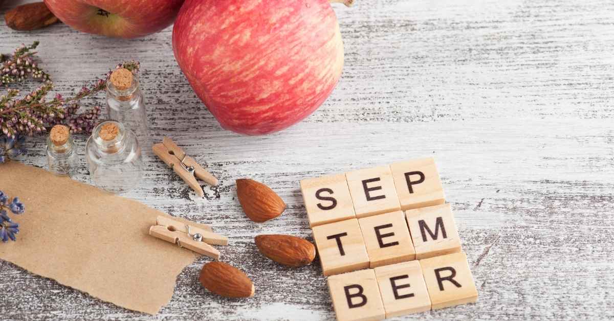 Apples, almonds, a clip and September spelled out on wood squares