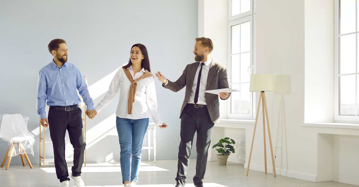 A happy buyer couple walking through a Scottsdale home for sale with their agent