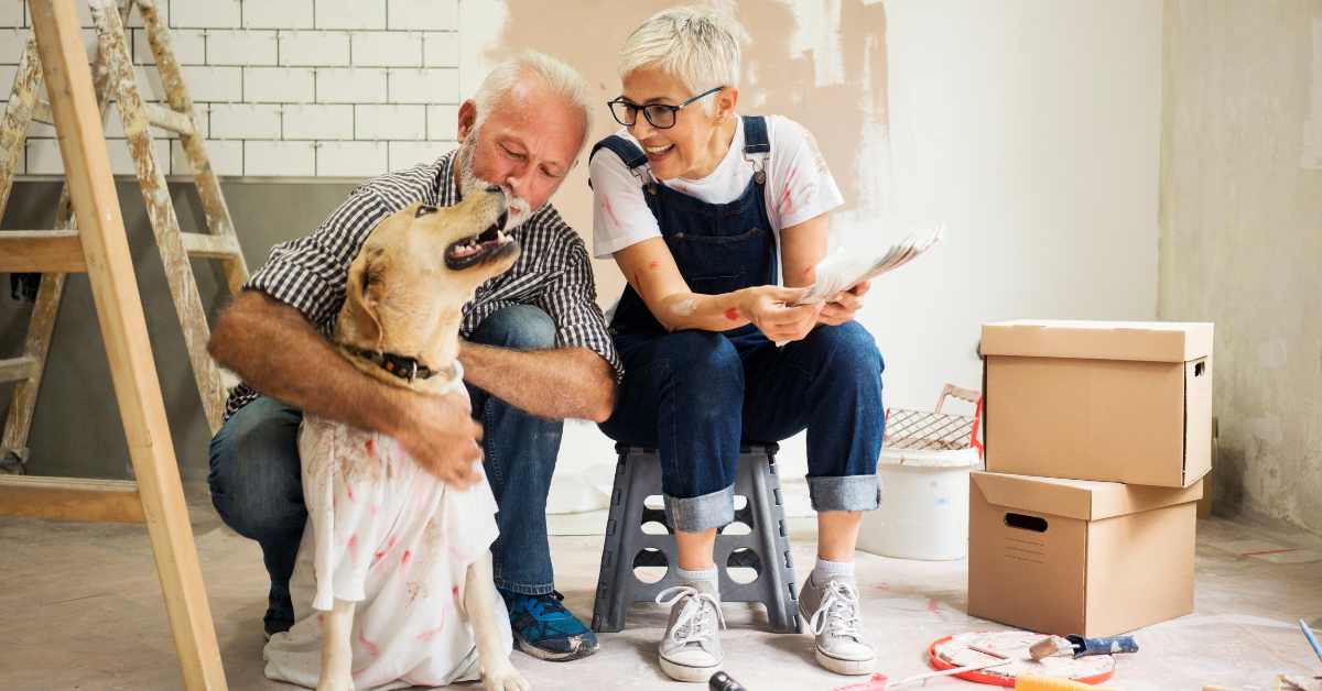 A couple with their dog doing some painting and remodeling in their Scottsdale home