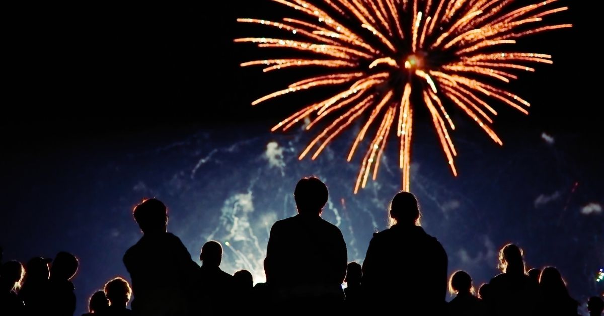 Silhouettes of people watching 4th of July fireworks in Scottsdale, Arizona