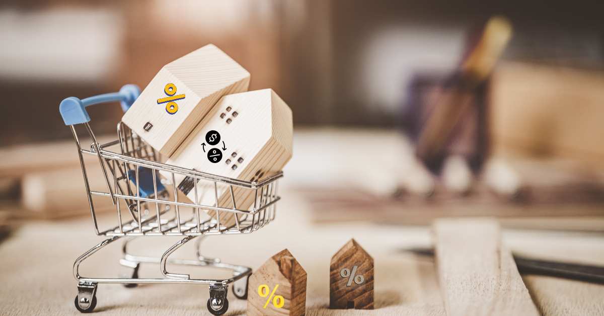 Little wooden Scottsdale homes with interest rate symbols on them, some in a shopping cart.