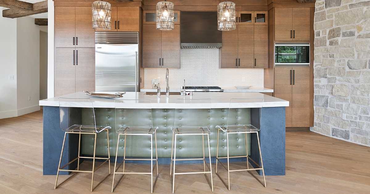 Kitchen in a home in Scottsdale with wood cabinets and a padded island with blue paint on the sides