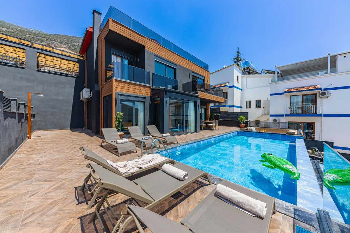 Modern custom home with a backyard pool and outdoor living area.