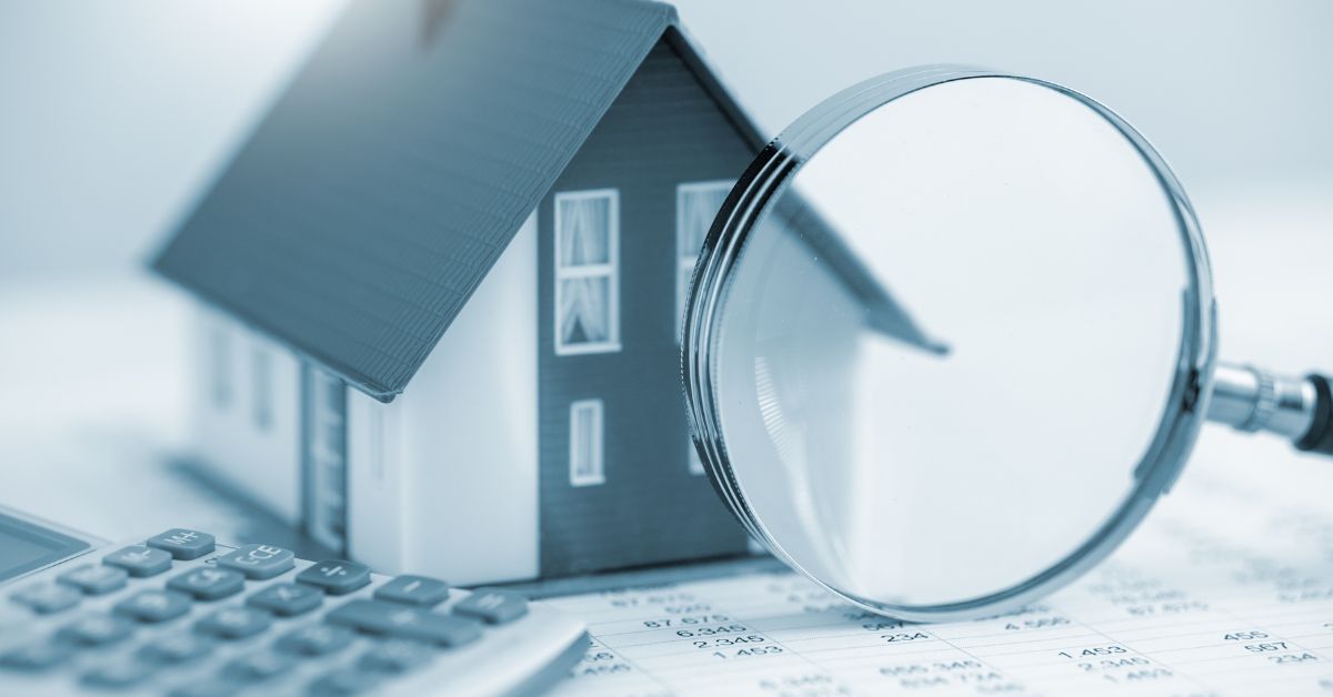 A little Scottsdale home with a magnifying glass and a sheet of paper with dollar amounts on it along with a calculator