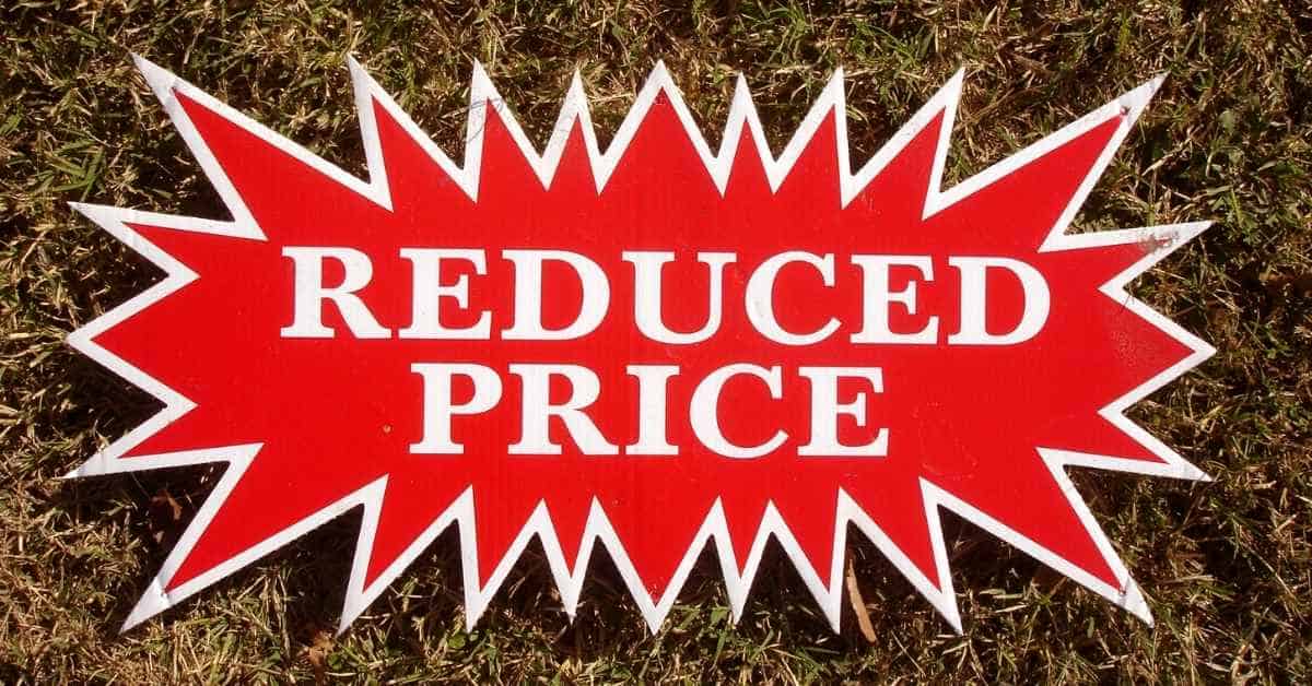 A red sign saying price reduced on a Scottsdale home for sale